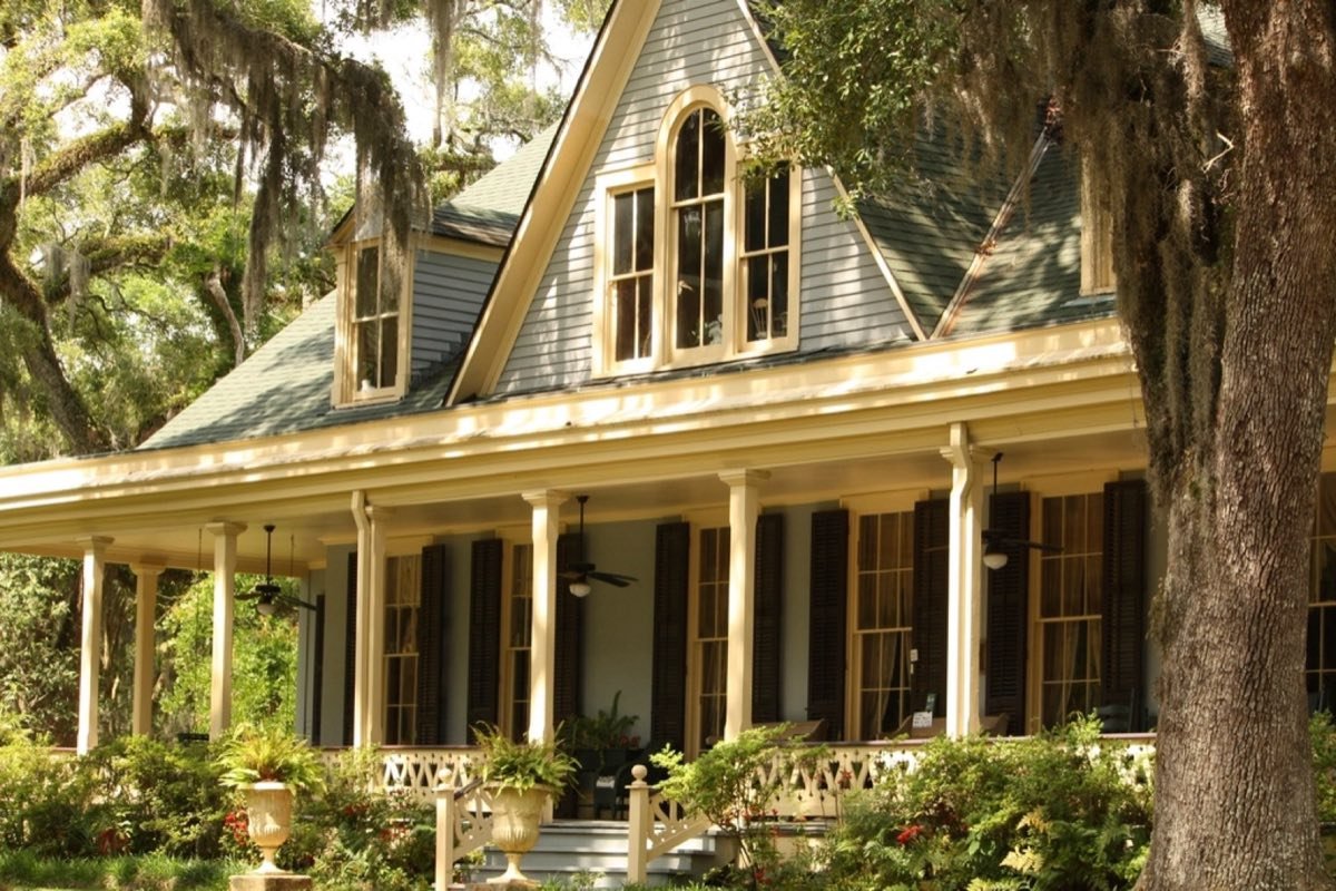 A large covered porch on a student house, lit in the evening